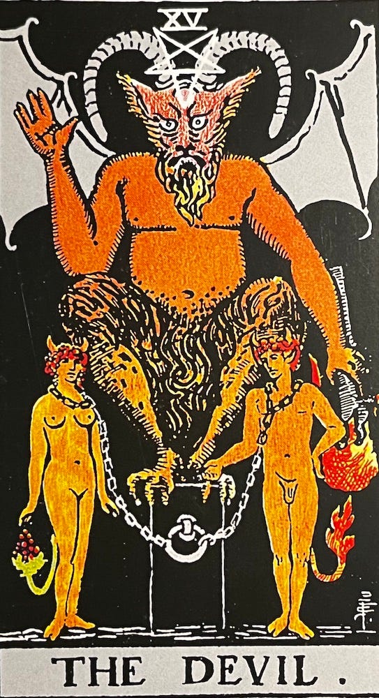 a large devil figure sitting atop of block of some kind. He has horns and an upside-down pentacle on his head. On his back are the wings of a bat. In his left hand, he is holding a torch which is n a down position and his right hand is up, almost like he’s waving. Two human figures, a woman on the left, and a man on the right, are nude and chained loosely to a block.