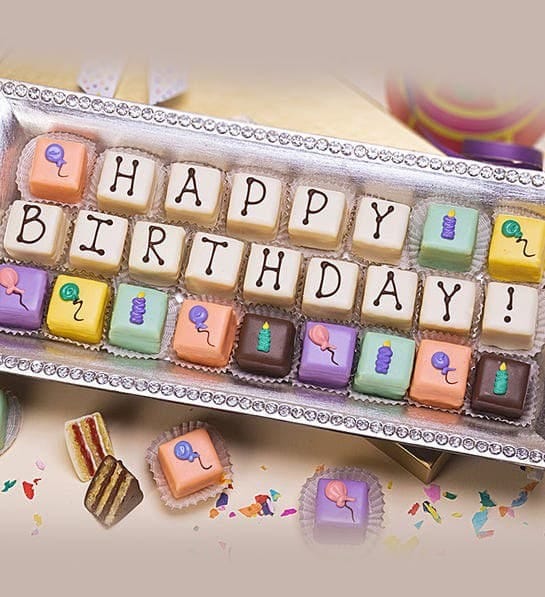 A box of small chocolate engraved with letters making up "Happy Birthday".
