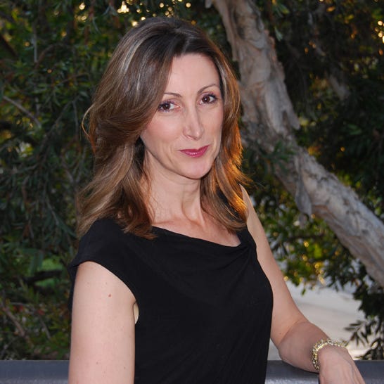 A portrait picture of Whittier College’s own environmental science and biology professor Cinzia Fissore smiling in front of a tree.