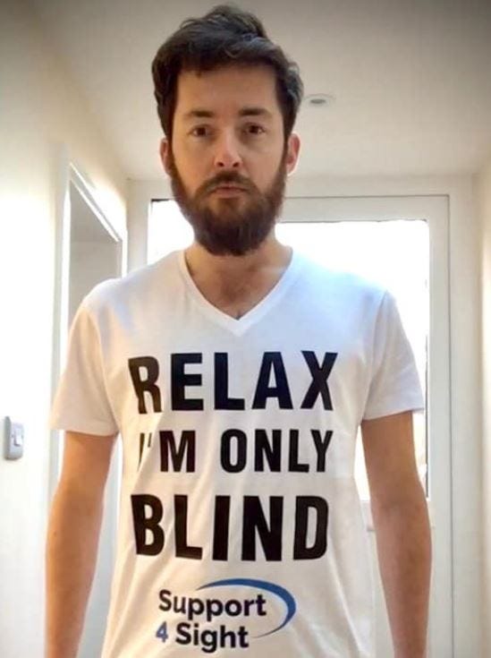 Alex Innes wearing a T shirt that reads Relax I’m Only Blind for charity Support4Sight