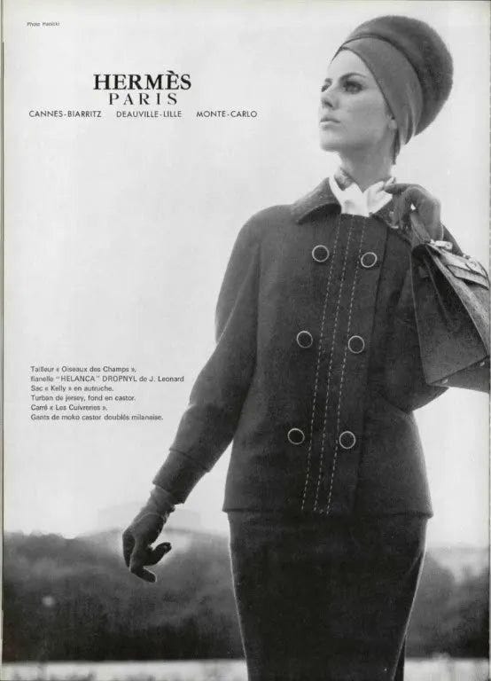 Old ad of Hermes with woman and handbag.