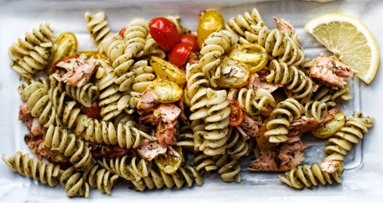 A Plate of Lemony Salmon with Rotini and Tomatoes, with a Lemon Wedge