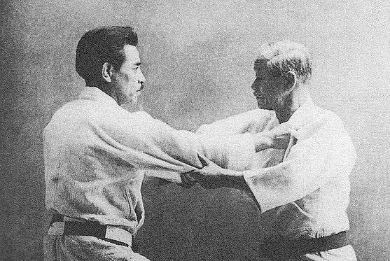 Kyuzo Mifune (left) and Jigoro Kano (right) practising judo. After learning from Kano, Mifune went on to become a master of judo; with some considering him the greatest technician ever, besides Kano.