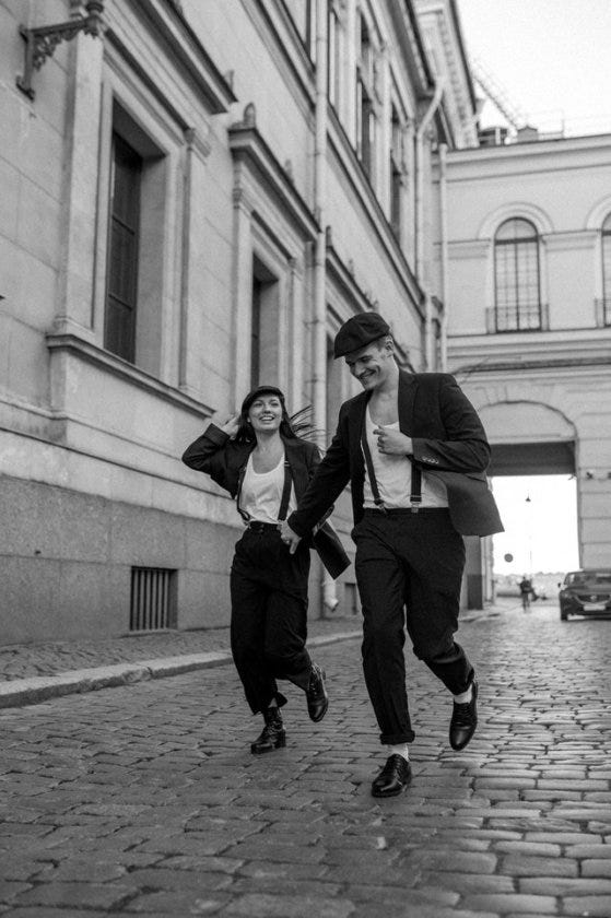 Laughing couple running.