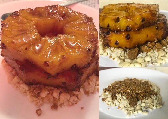 Two slices of stewed and grilled pineapple stacked atop a crumble made from cashew nuts and peanut brittle on a white plate