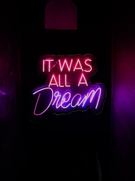 Quote saying “It was all a Dream” with neon lights on a dark background.