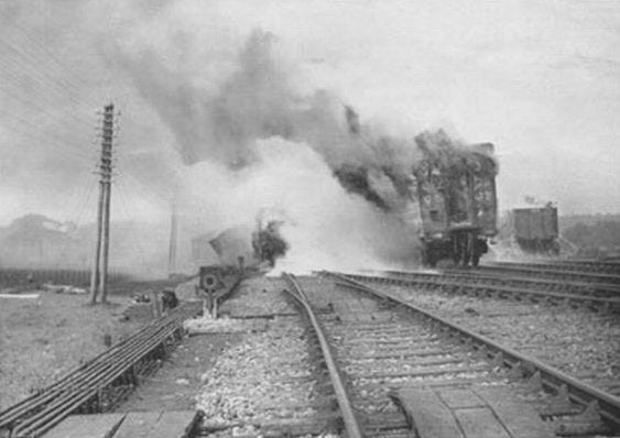 Grainy black and white photo of a burning train