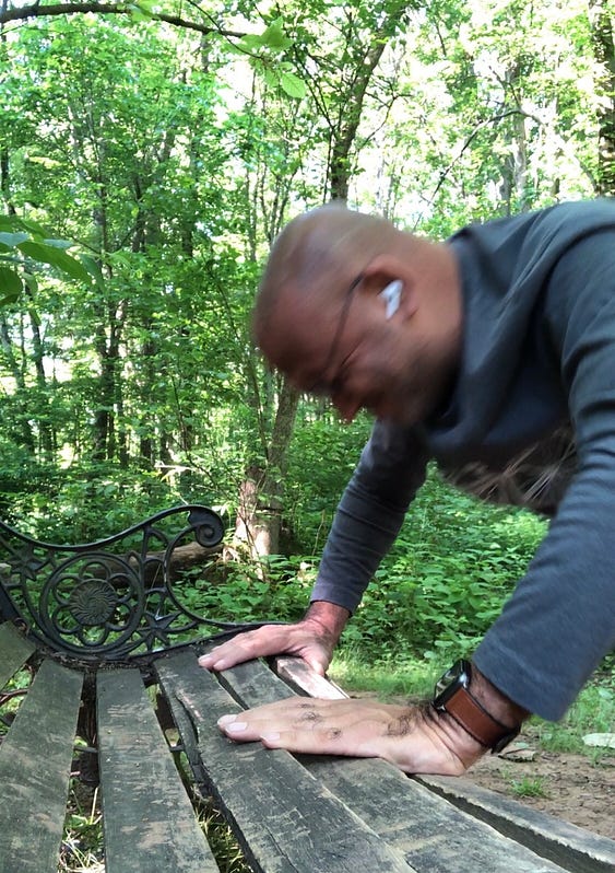 The writer doing push-ups in a park