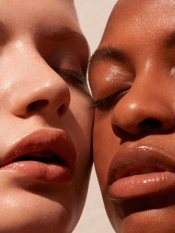 2 girls face close-up in sunlight.