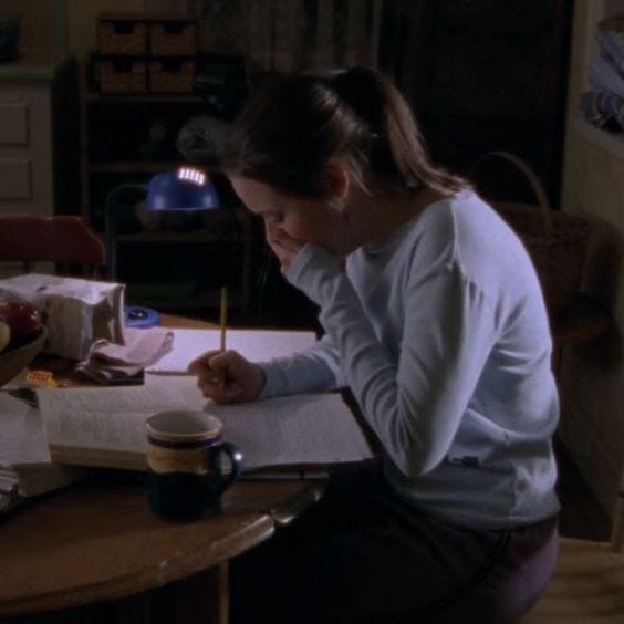 A girl (Rory Gilmore) yawning at the table.