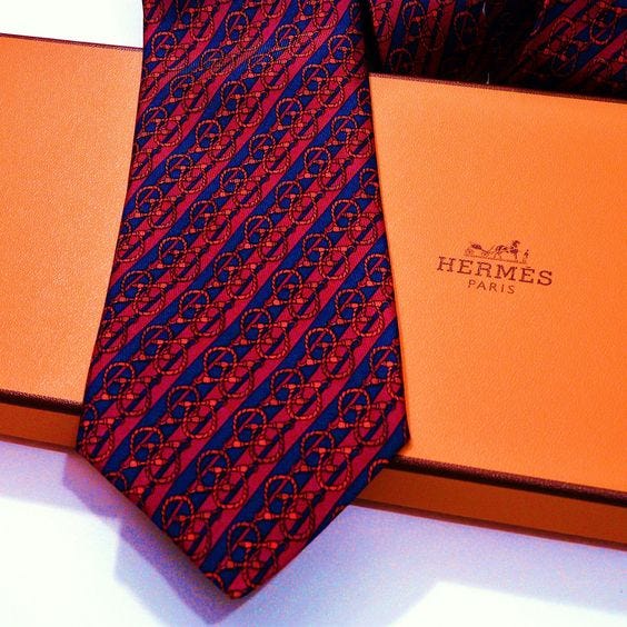 Hermes silk tie over an orange box.