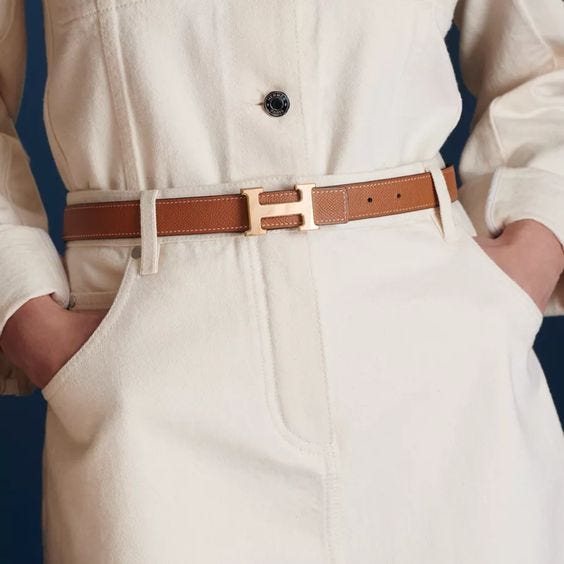 A man wearing a famous Hermes H buckle belt designed by Catherine Karolyi