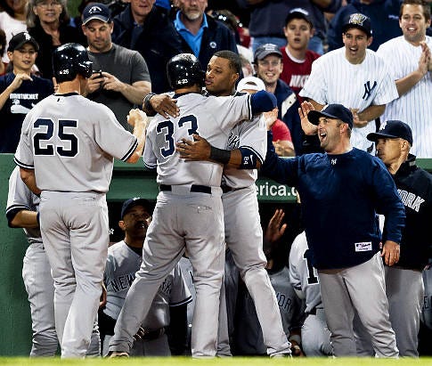 Nick Swisher (33) finds mates embrace efforts as his 3-run shot in 4th puts Yanks on board.