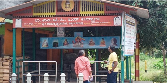 Two men reading a board of a public place in South India