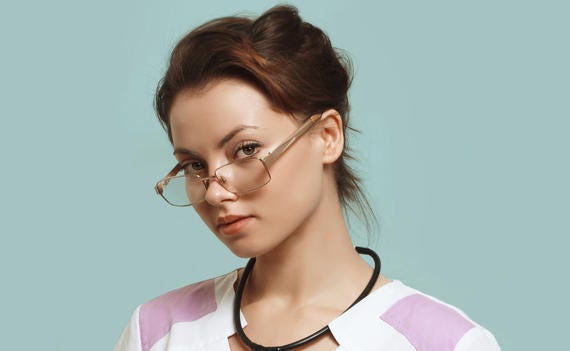 Attractive young nurse with glasses and a shy expression