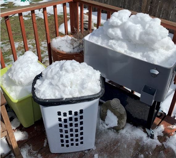 3 different large containers of snow including a laundry hamper with a trash bag in it.