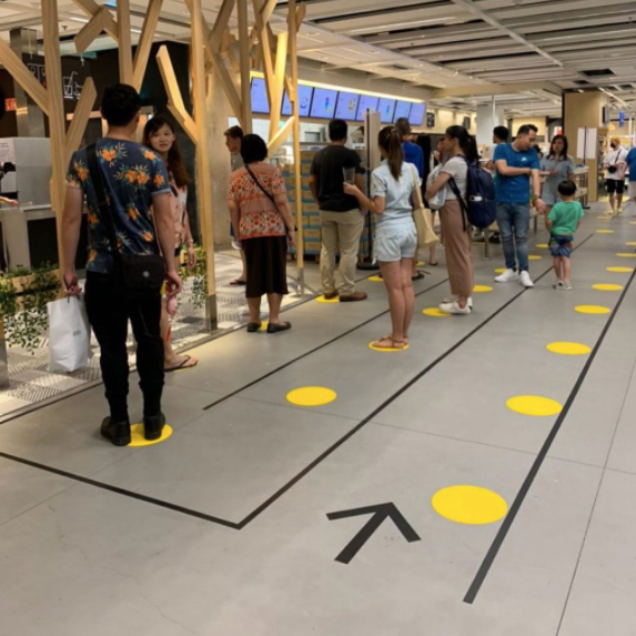 Arrows and circles tell people where to stand in line