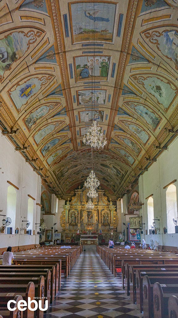 Aisle with murals on the ceiling of the Argao Church