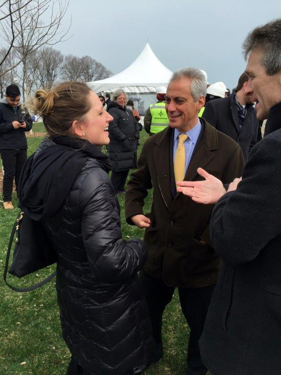 A photo of Megan Nufer and former Mayor of Chicago Rahm Emmanuel mid-conversation outside at a press conference.