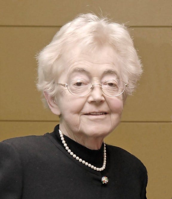 Judge Betty Bins Fletcher, with grey hair and glasses, wears pearls and a black wardrobe.