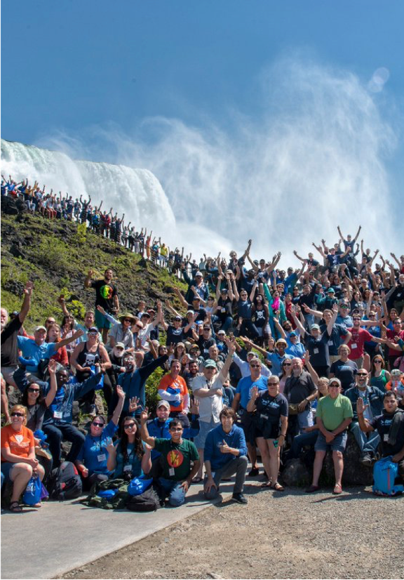 Waterkeepers convene and raise their arms in celebration at Niagara Falls in spring 2018.