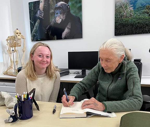 Jane Goodall (right) signs a book for Global Futures student Reilly Hammond.