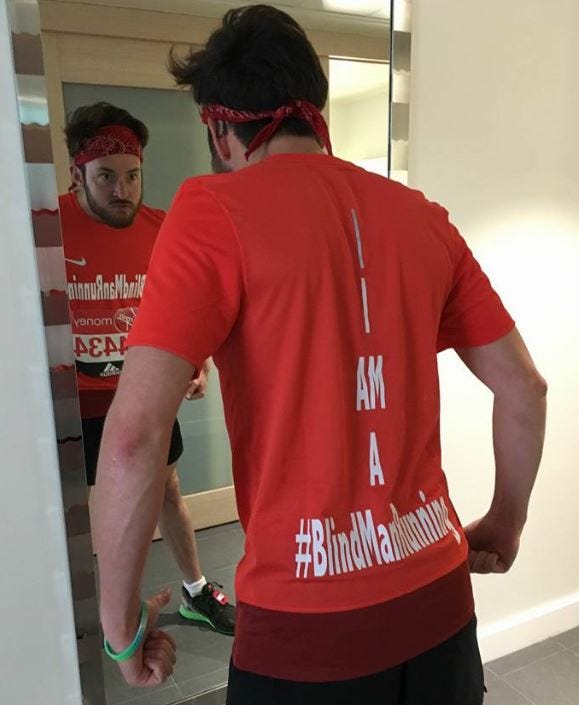Alex Innes in a gorilla pose in front of a mirror, psyching himself up for the London marathon