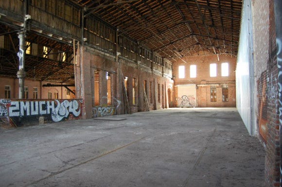 Inside of a large abandoned brick building