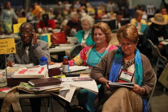 Delegate Tammy Estep from Virginia bows her head in prayer prior to the start of the Monday April 30 plenary at the 2012 United Methodist General Conference. A UMNS photo by Kathleen Barry.