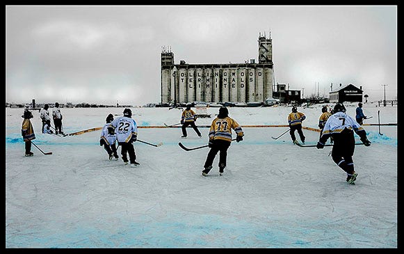 Kids playing hockey on a frozen lake