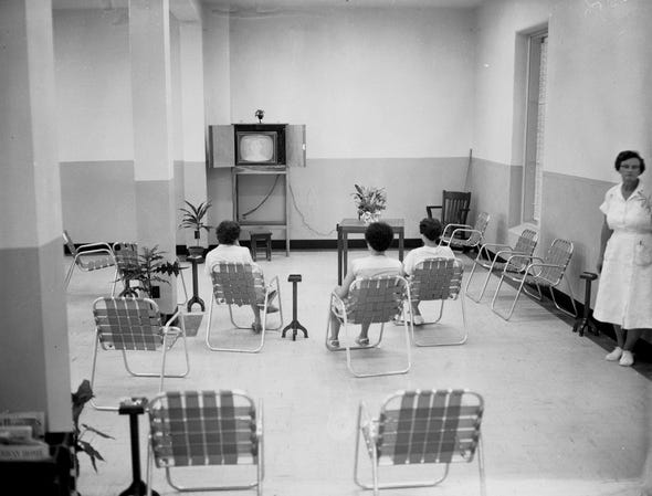 People watching TV in a hospital ward. 1950s.