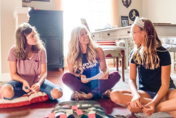 Christie sat cross legged on the floor between her two daughters rehearsing a trainging session.