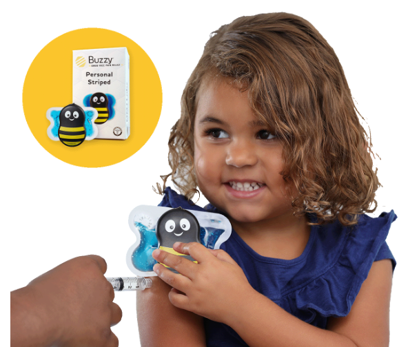 A smiling young girl receives a vaccination while holding a Buzzy bee-shaped vibrating pain relief device on her arm.