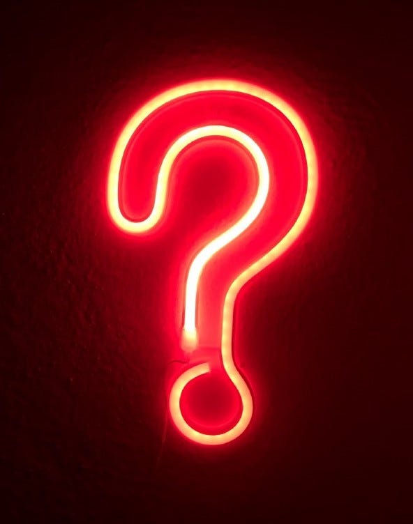 Red neon sign question mark