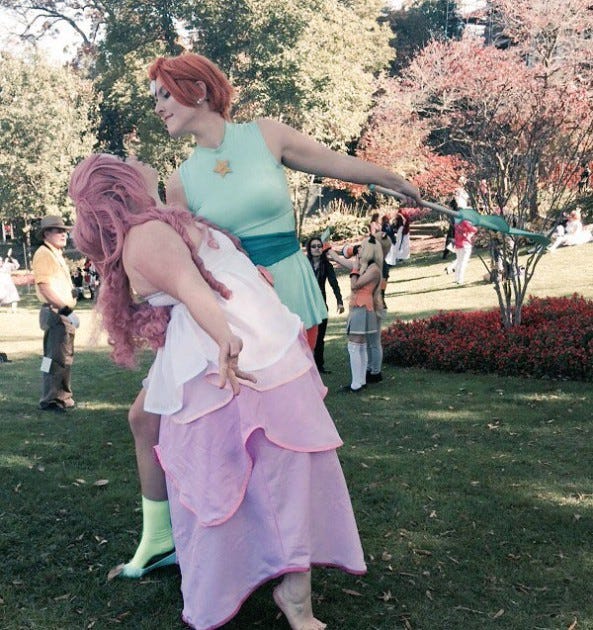 The author cosplaying as Rose Quartz with her girlfriend as Pearl.
