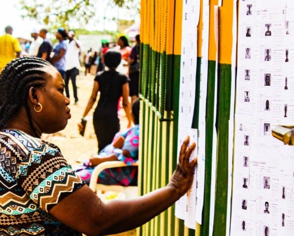 South African woman studies the candidates in a local election