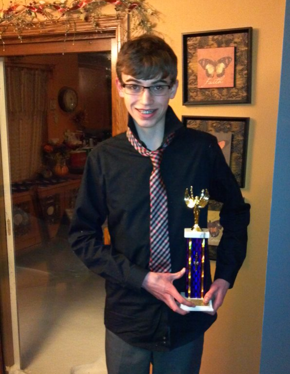 Me posing with my high school forensics trophy