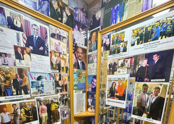 The changing room at Sam’s Tailor, adorned with photos of celebrities and royalty showcasing their pieces from this legendary tailoring house