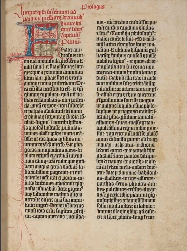 Page from the Biblia Latina printed in two columns in black and red ink. There is a decorated initial at the start of the text. There is a rubric just above.