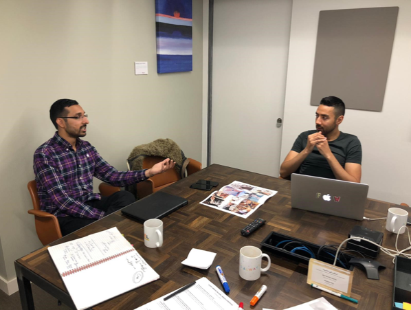 Two members of the BT Design team discussing research methods around a desk.