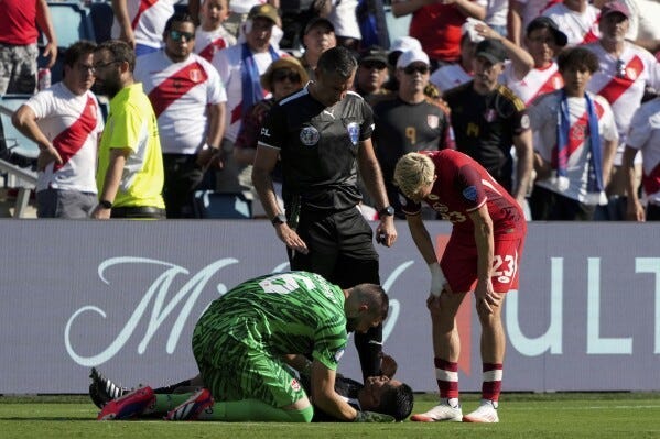 Maxime Crepeau checks in on a linesmen who fainted in the hot sun during a match. Liam Miller and a referee stand around him