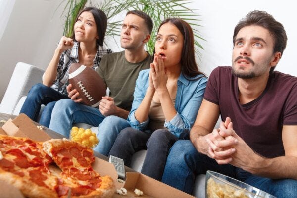 Group of friends watching American football