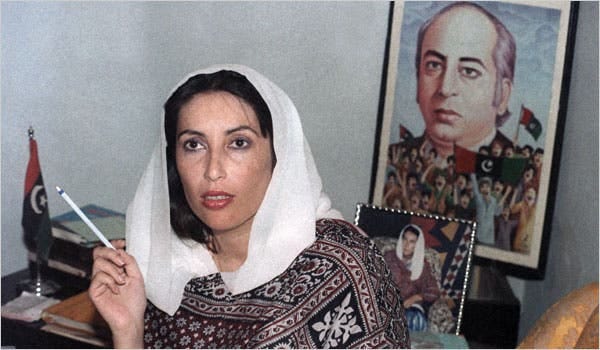 Benazir Bhutto in her thirties, in front of a picture of her father