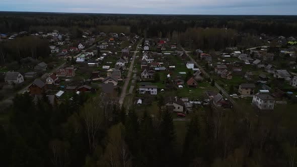 Aerial View of Small Forest Town with Lush Greenery and Surrounding La