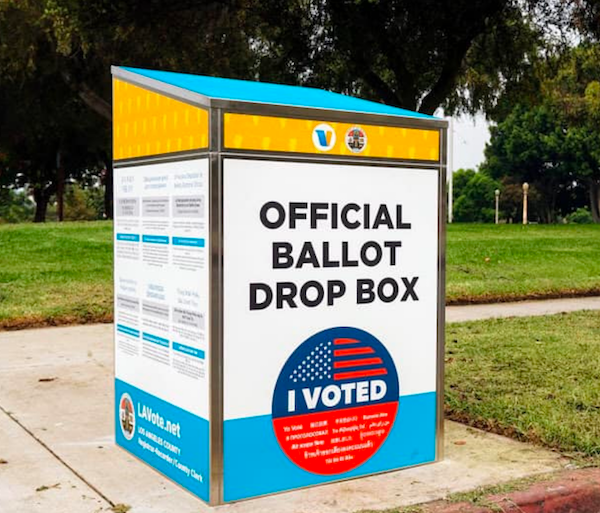 Very colorful ballot box in bright primary colors with the word VITE prominently featured