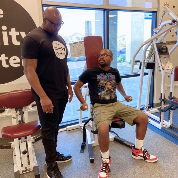 two people working out in a fitness gym on equipment