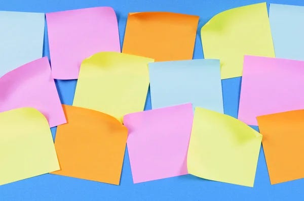 Sticky notes in various colours against a blue background.