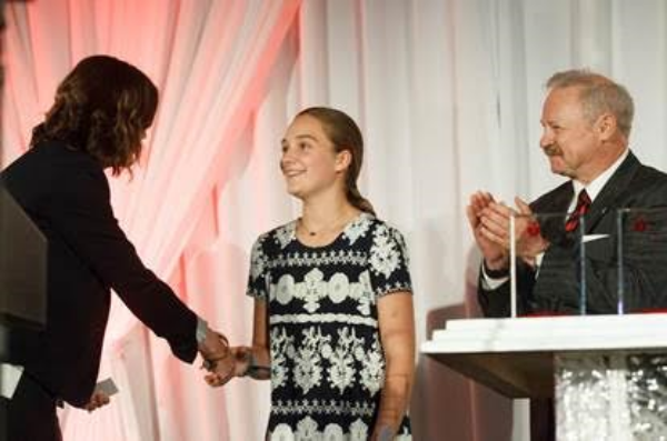 Aerin receiving an award from the American Heart Association for her life-saving quick thinking.