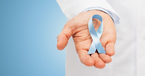 A doctor holding blue ribbon