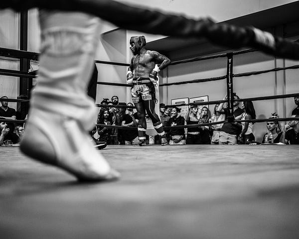 Black and white picture of a boxing ring during competition